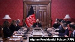 Afghan President Ashraf Ghani talks with U.S. special representative Zalmay Khalilzad at the presidential palace in Kabul. 