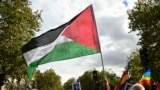 A protester waves a Palestinian flag during a march asking for the "recognition of the State of Palestine and the end of the genocide", in Paris on September 21, 2025.